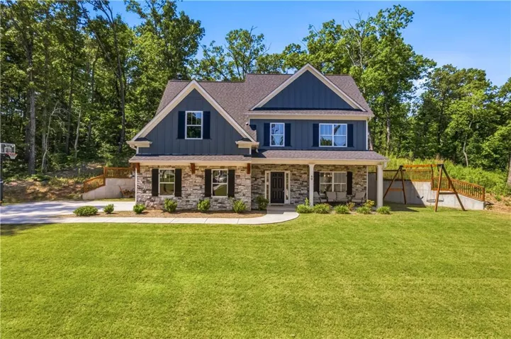 Two-story residence featuring a combination of stone and board and batten siding