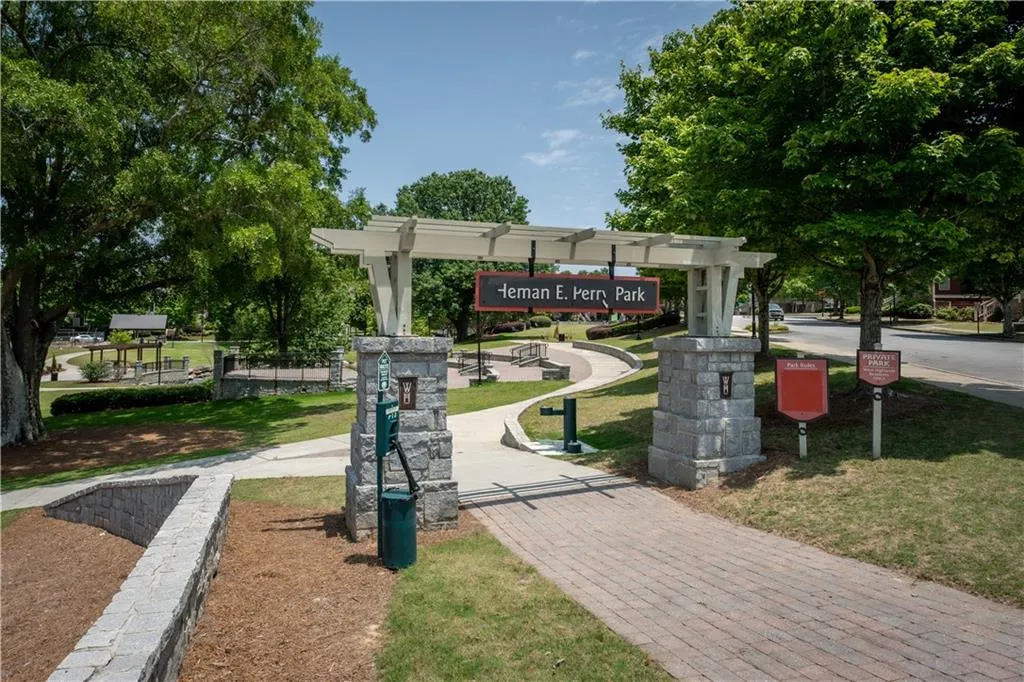 View of community featuring a lawn and a pergola