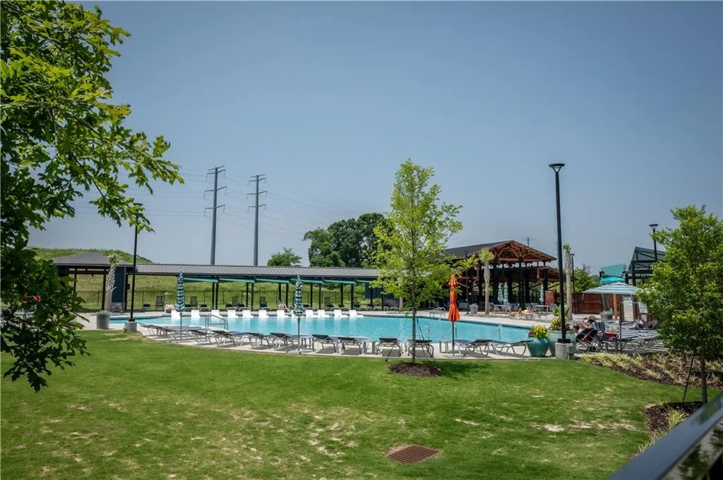 Community pool featuring a lawn, a gazebo, and a patio area