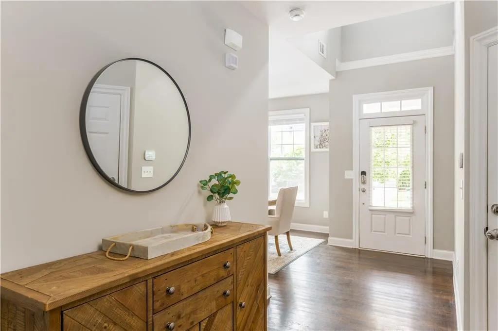Entrance foyer featuring dark wood finished floors and baseboards