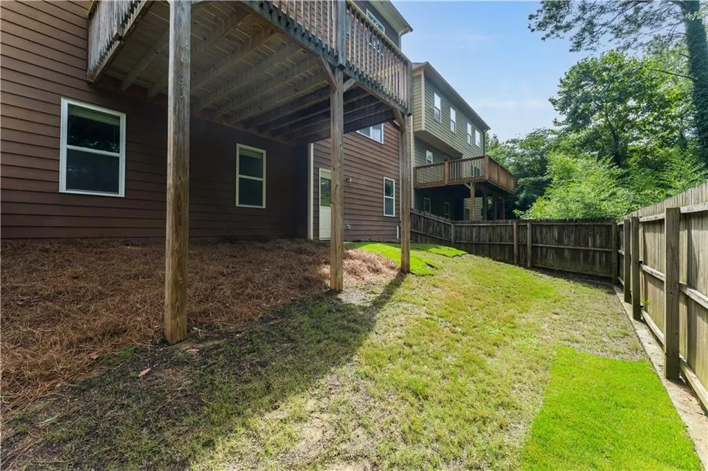 Fenced backyard with a deck