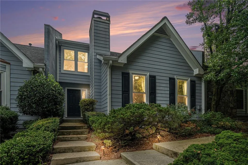 View of front facade featuring a chimney View of front facade featuring a chimney