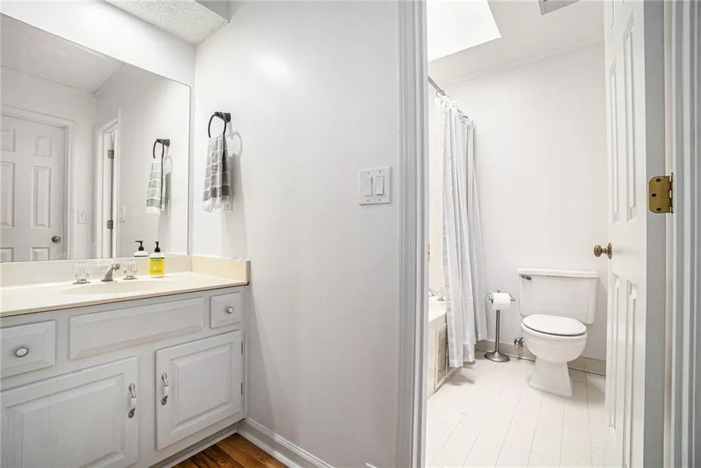 Bathroom with vanity and shower / bath combination with curtain Bathroom with vanity and shower / bath combination with curtain