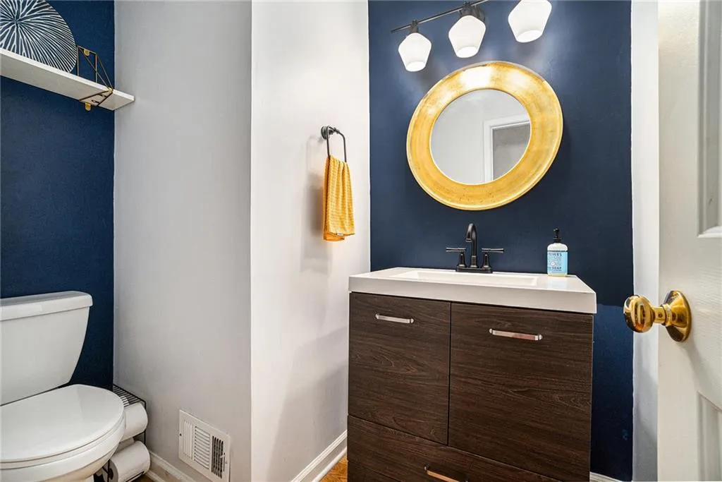 Half bathroom featuring vanity and toilet Half bathroom featuring vanity and toilet