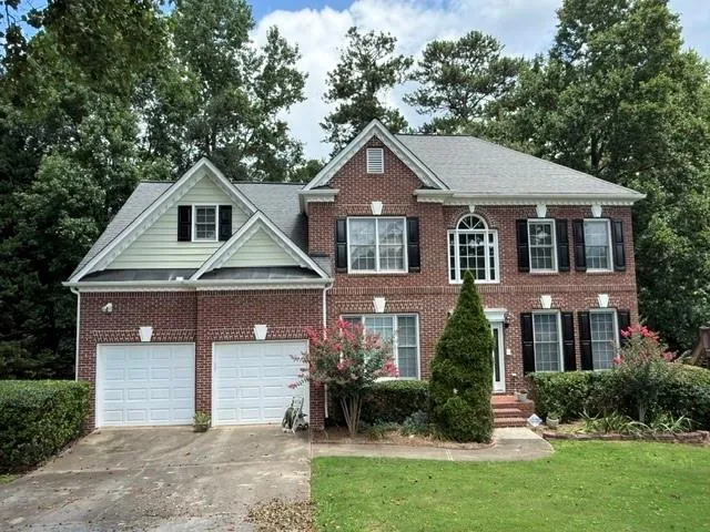 Traditional brick exterior with light-colored siding accents