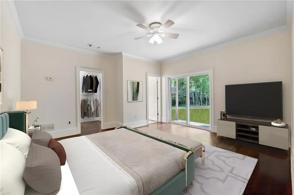 Bedroom with access to exterior, dark hardwood / wood-style floors, ceiling fan, and ornamental molding