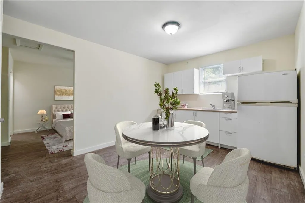 Dining area with dark hardwood / wood-style flooring