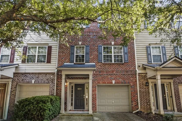 Brick and siding exterior with shutters, covered entry, and attached garage