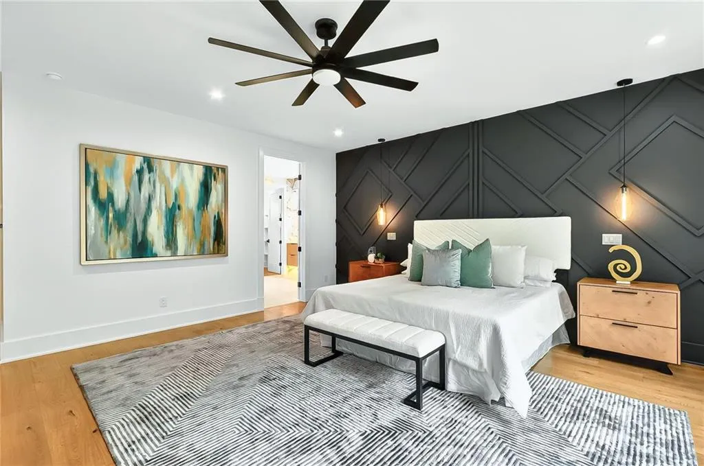 Bedroom featuring light wood-style flooring, baseboards, recessed lighting, ceiling fan, and ensuite bathroom
