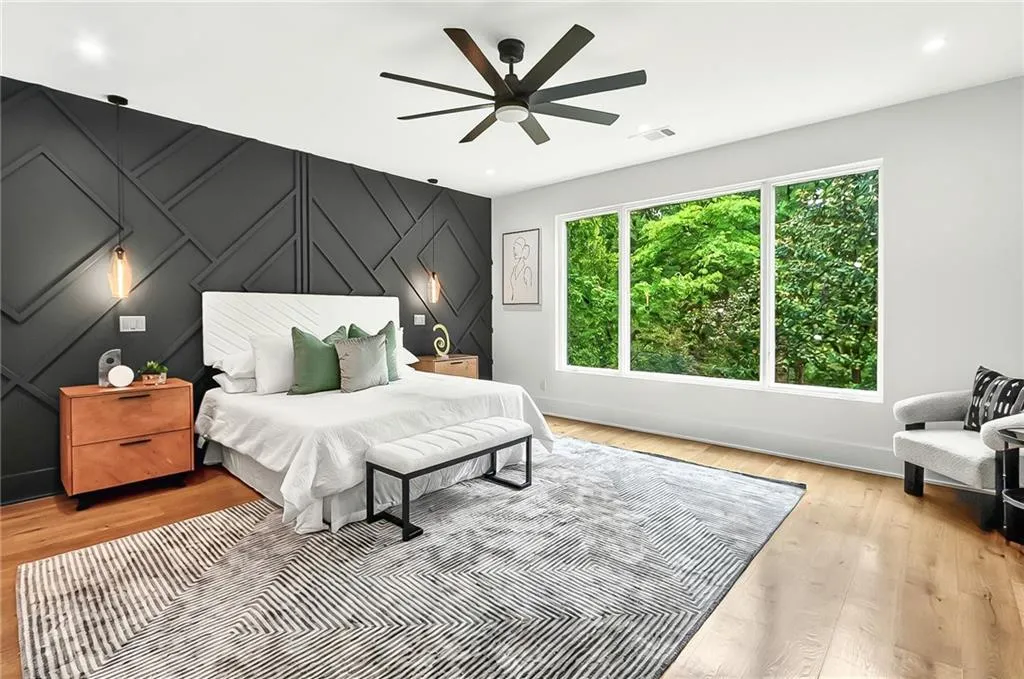 Bedroom featuring baseboards, light wood finished floors, and a ceiling fan