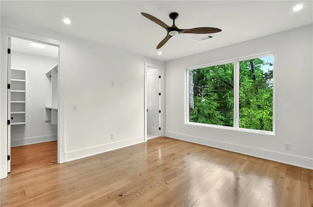 Spare room with ceiling fan, light wood-style floors, baseboards, and recessed lighting