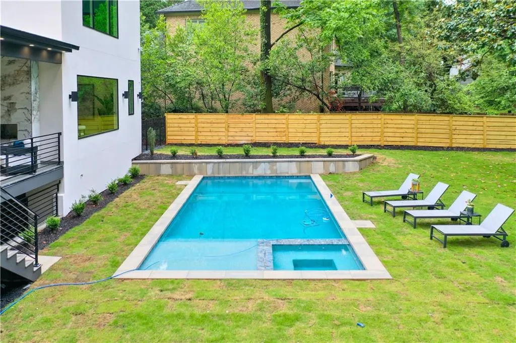 View of swimming pool featuring a pool with connected hot tub