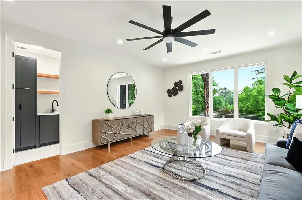 Living room with a ceiling fan, light wood-style floors, recessed lighting, and baseboards