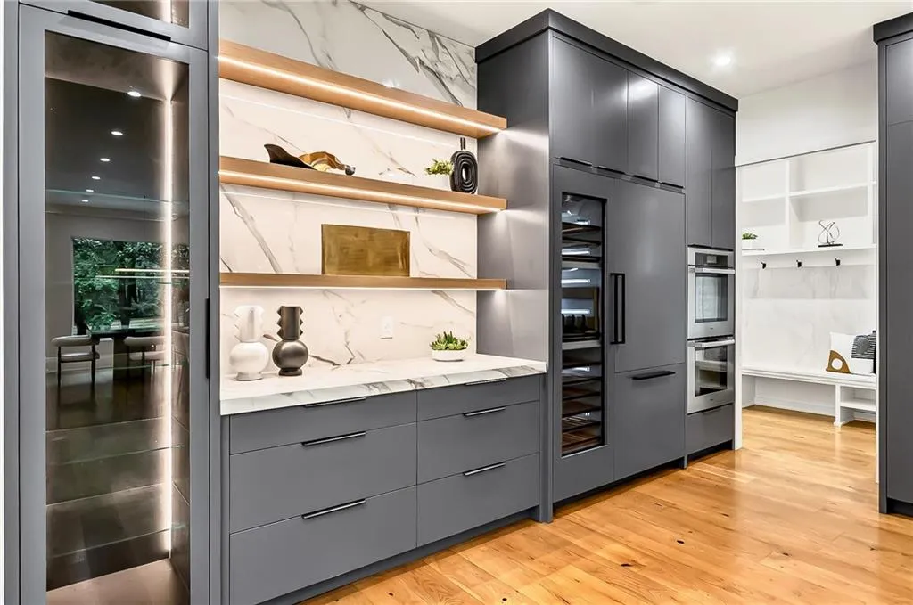 Kitchen featuring open shelves, gray cabinetry, light wood finished floors, double oven, and modern cabinets