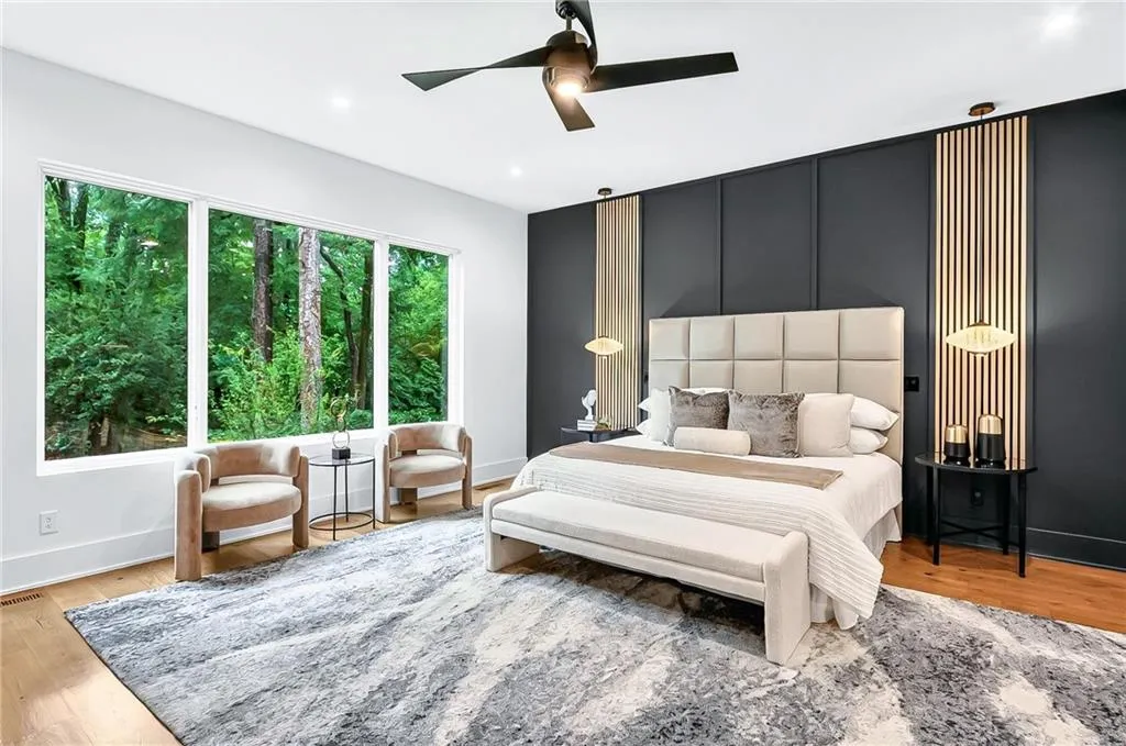 Bedroom featuring baseboards, light wood-style floors, and ceiling fan