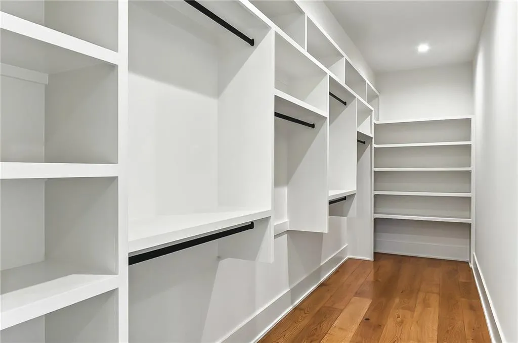 Walk in closet featuring wood finished floors