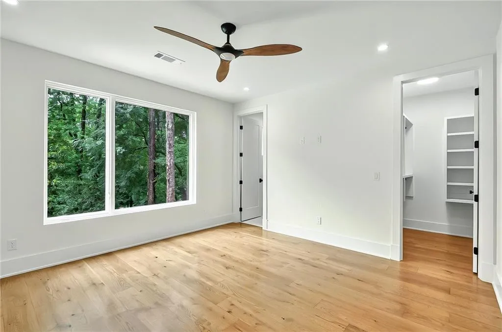 Unfurnished room with ceiling fan, light wood-style floors, baseboards, and recessed lighting