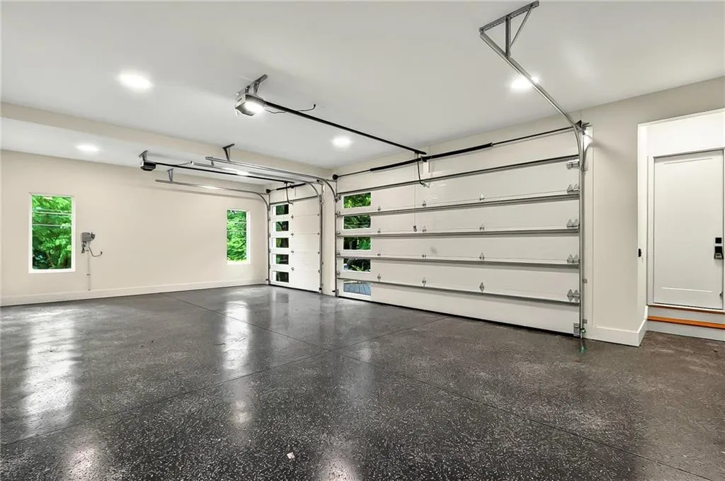 Garage with a garage door opener and baseboards