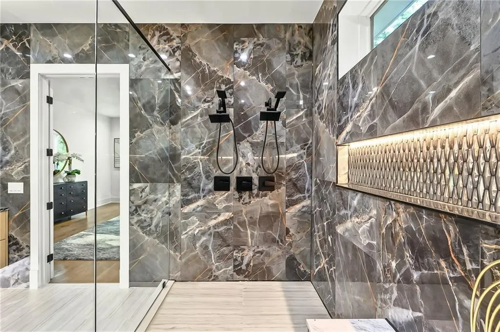 Full bathroom with tile walls and a marble finish shower