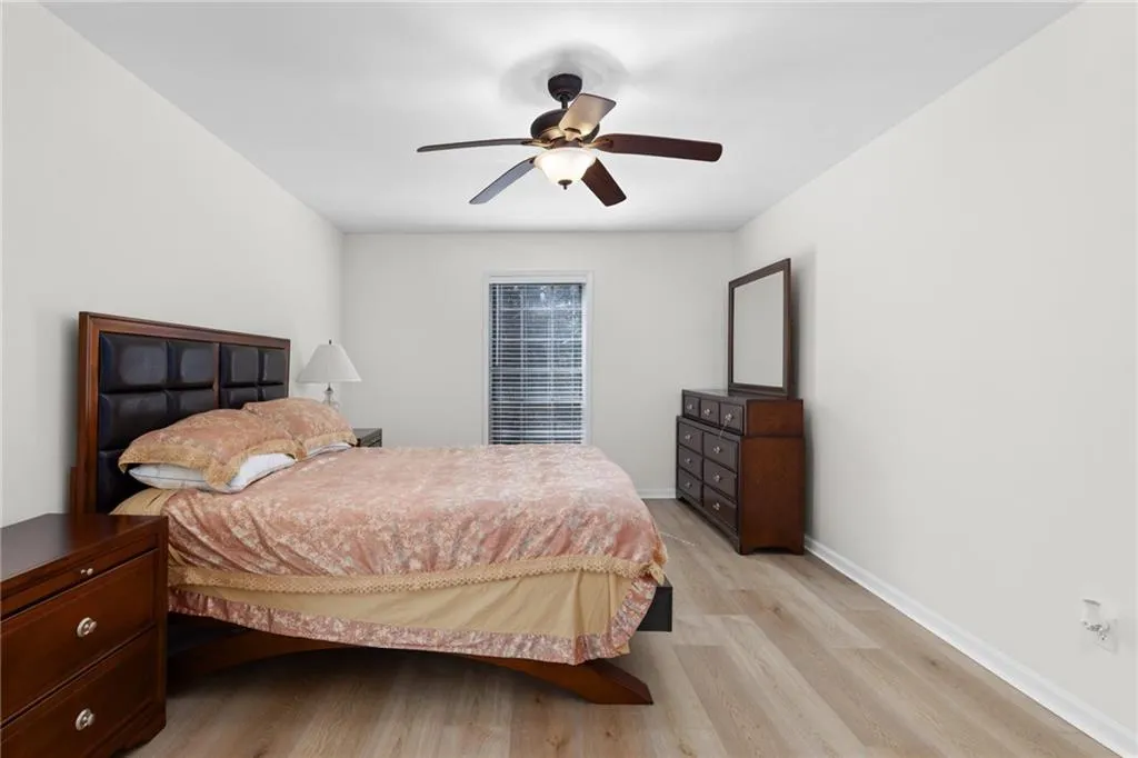 Bedroom featuring light wood-style floors and a ceiling fan