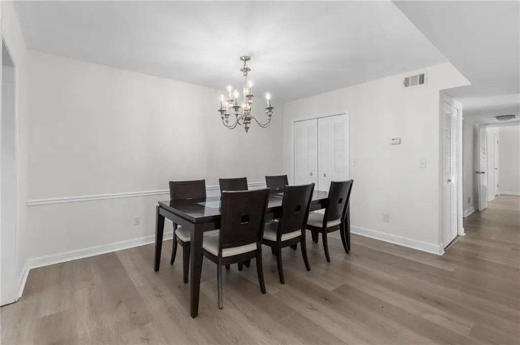 Dining room featuring light wood-type flooring and a chandelier