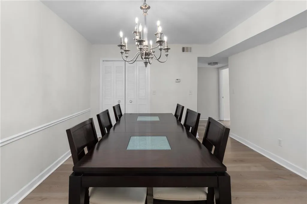 Dining room featuring light wood-type flooring and a chandelier
