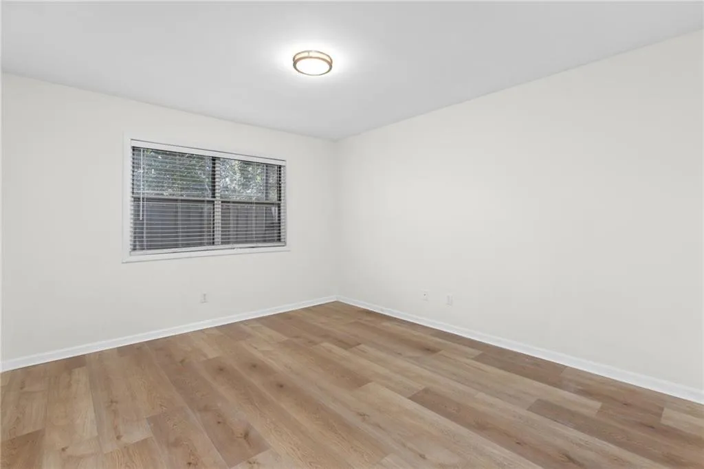 Empty room featuring light wood-type flooring and baseboards