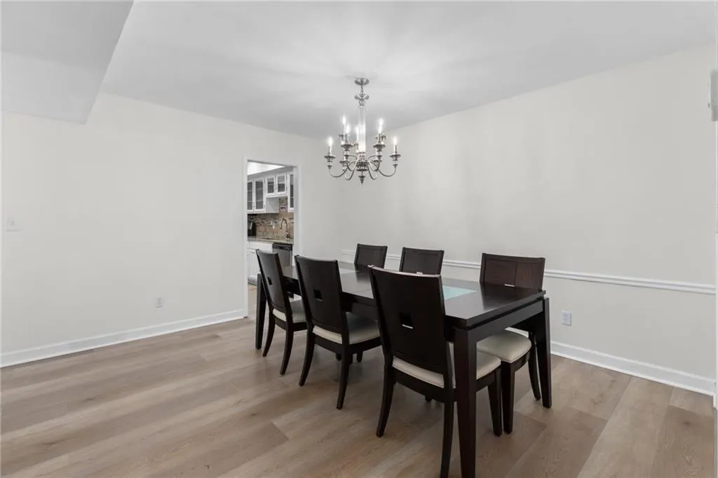 Dining area featuring light wood-type flooring and a chandelier