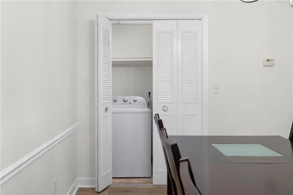 Laundry room with washer / dryer and wood finished floors