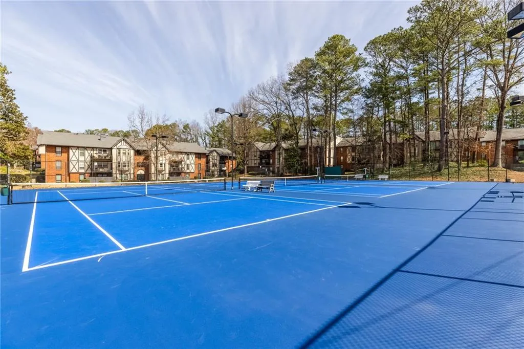 View of tennis court with community basketball court and a residential view