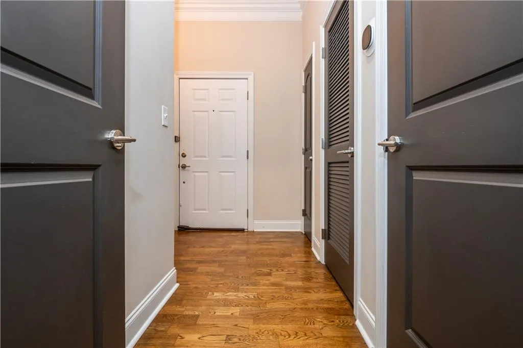 Wood-finish flooring throughout, complemented by crown molding and white trim