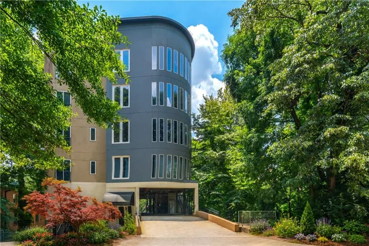 Modern architectural exterior with a curved facade and multiple vertical windows