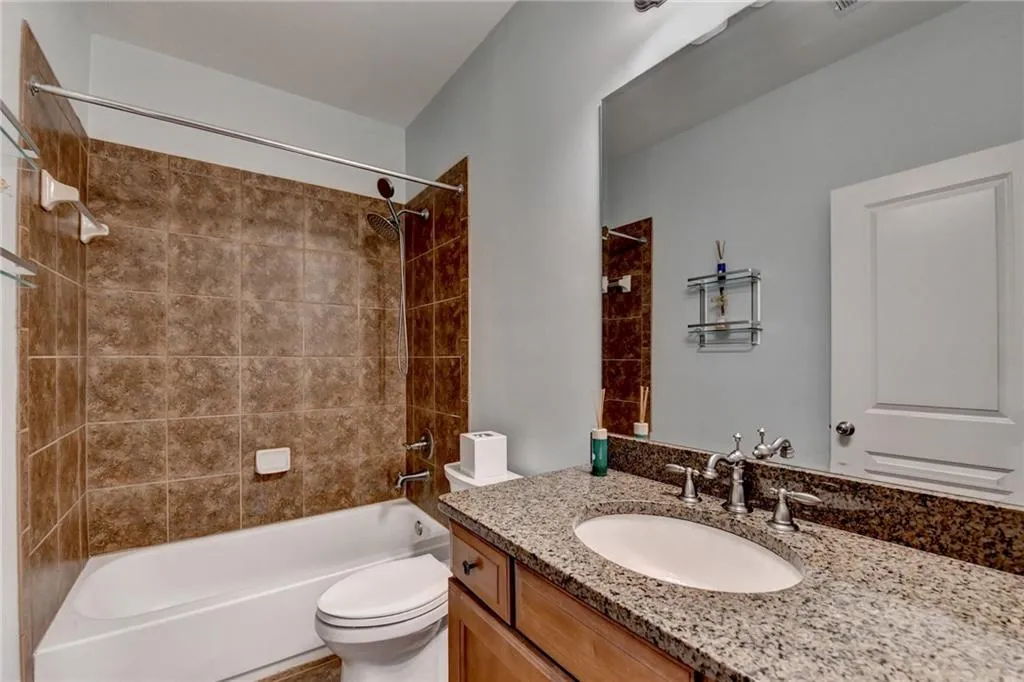 Hall Bath with new toilet, shower head/sprayer, and inset shelves