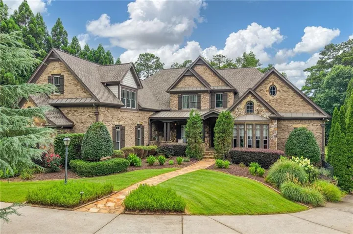 Stone and brick exterior with multiple gables and dormers