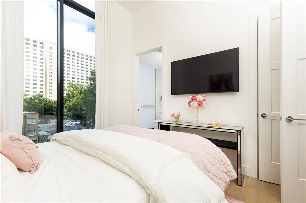 On the other side of the unit, this beautiful secondary bedroom with ensuite bath provides privacy with the same lofty feel.