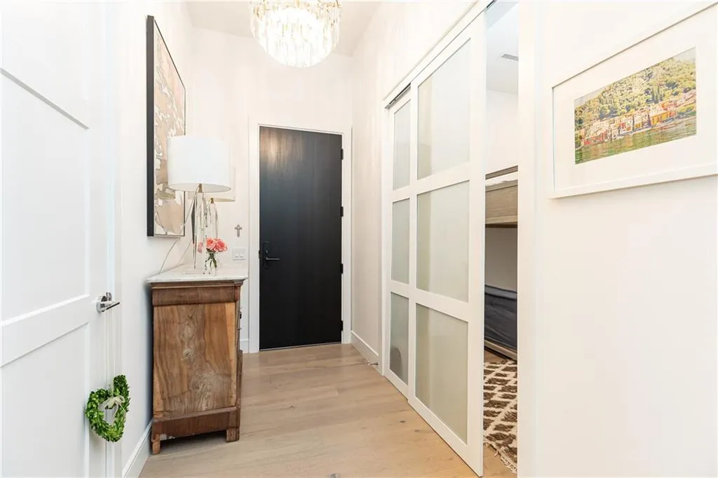 Off the elegant entrance hall, the sliding doors lead to an additional bonus space which could be used as a guest room or office.