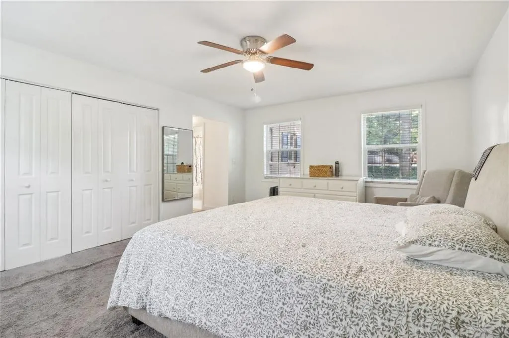 Carpeted bedroom featuring ceiling fan Carpeted bedroom featuring ceiling fan