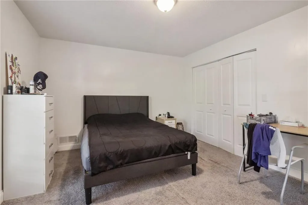 Bedroom featuring a closet and carpet floors Bedroom featuring a closet and carpet floors