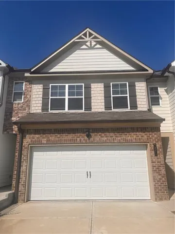Brick and stone veneer facade with shuttered windows