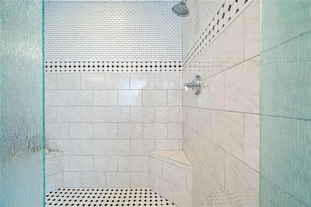 Oversize show with beautiful art deco tile and waterfall glass doors