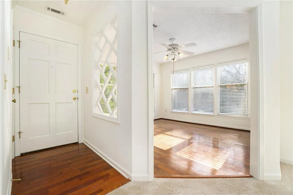 Entrance foyer featuring a wealth of natural light, dark hardwood / wood-style flooring, and a textured ceiling
