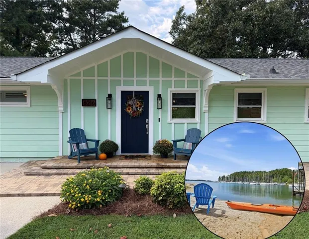 Mint green siding with white trim accents and a dark blue front door