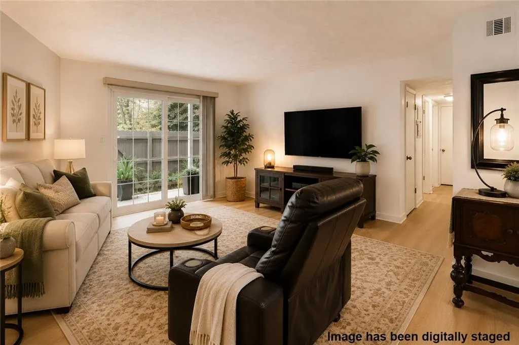 Inviting living room with sliding glass doors that bring in natural light and extend the living space outdoors. An easy, comfortable layout with a seamless connection to the dining area.