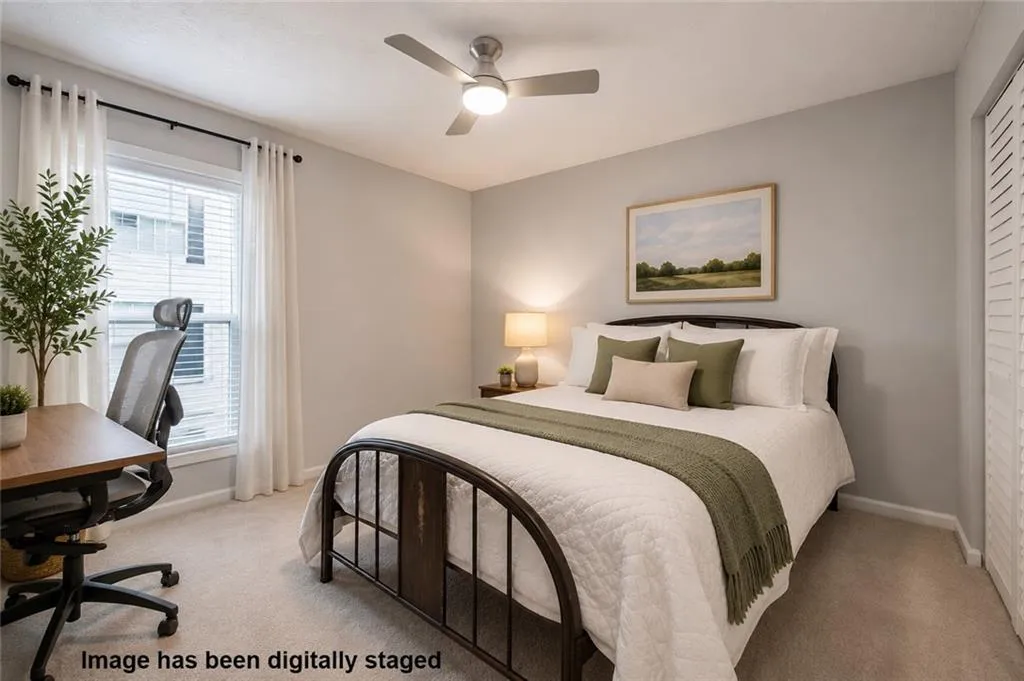 Bright secondary bedroom with generous natural light and plenty of room for a home office or study area.