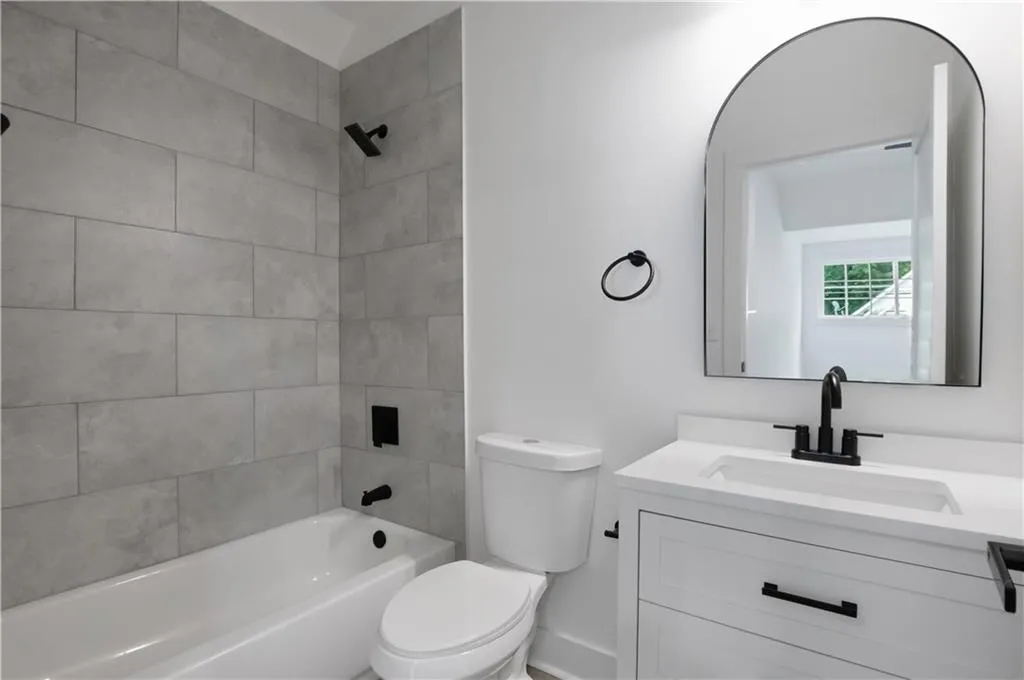 Bathroom featuring tub / shower combination and vanity