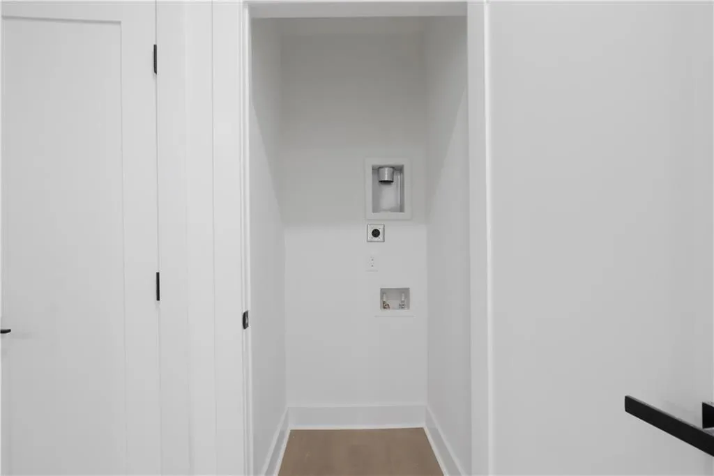 Laundry area featuring hookup for a washing machine and wood finished floors