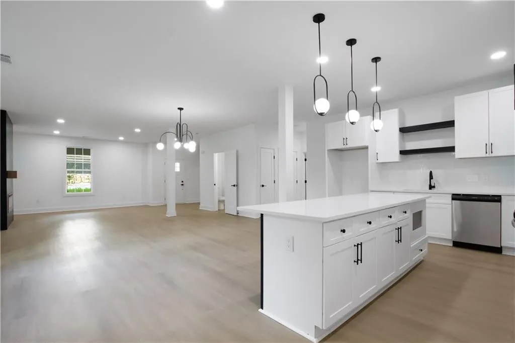 Kitchen with open shelves, recessed lighting, open floor plan, pendant lighting, and white cabinetry