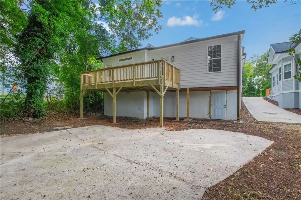 Rear view of house featuring a wooden deck