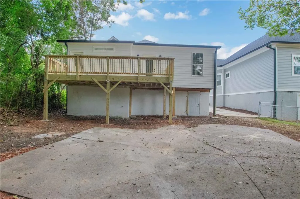 Back of property featuring a wooden deck