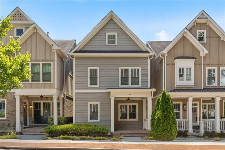 Modern Craftsman-style exterior featuring gray horizontal siding, white trim, and a prominent gable roofline
